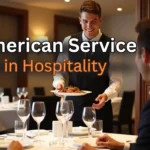 Waiter serving a pre-plated dish to a guest in a fine dining restaurant, illustrating American service style in hospitality.