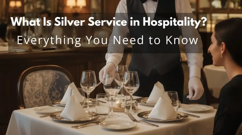 Professional waiter performing silver service, serving guest with fork and spoon in fine dining restaurant.